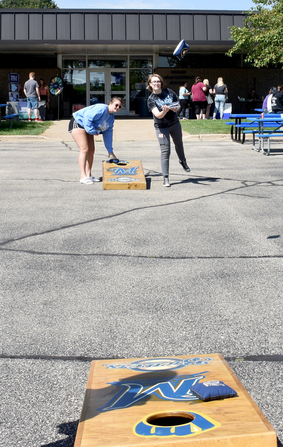 students playing bean bag toss