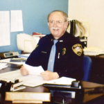 Police officer in uniform at desk