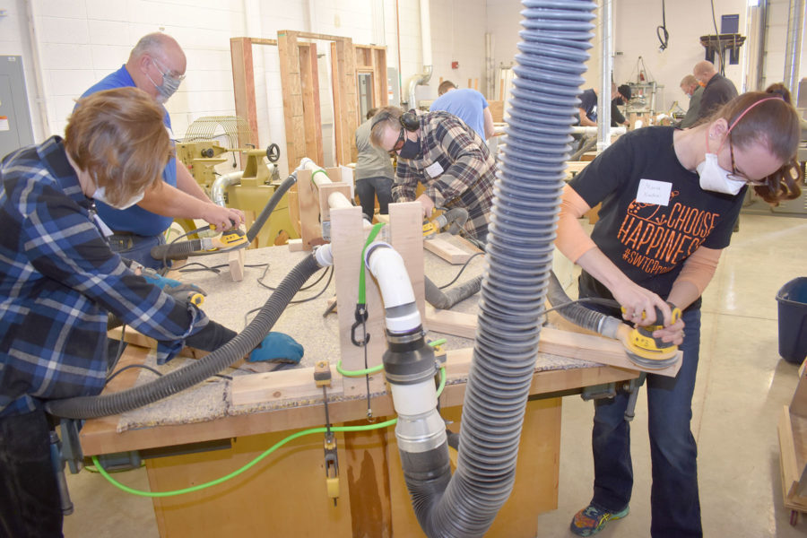 Employees volunteer time to make beds for local children