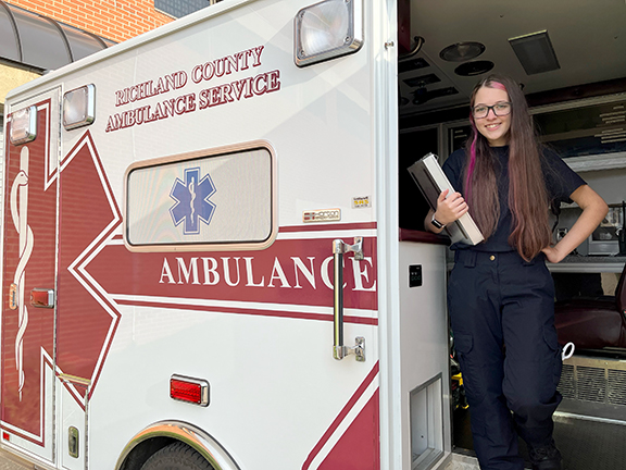 FEMALE STANDING INSIDE AMBULANCE