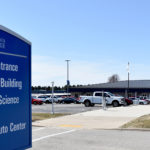 Exterior view of main campus building with blue signage.