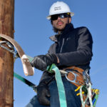 Male student on electrical pole.