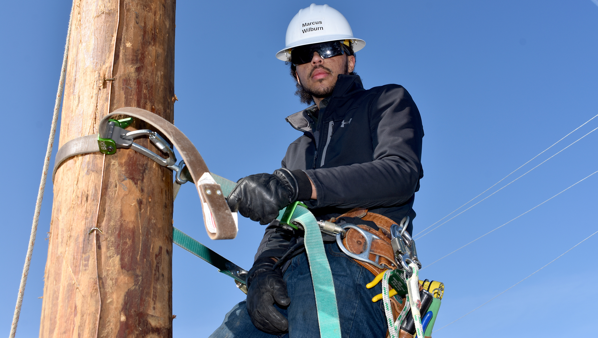 Male student on electrical pole.