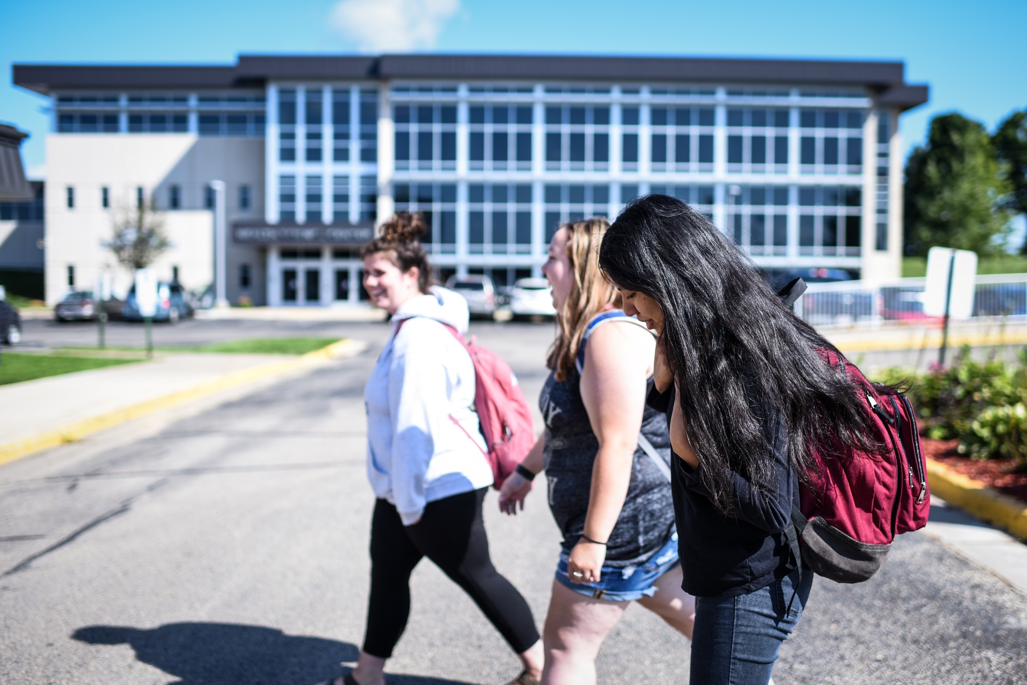 Three female students walking campus