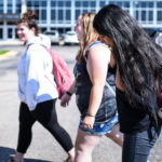 Three female students walking on campus