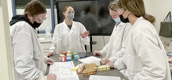 Teacher and students in lab gear