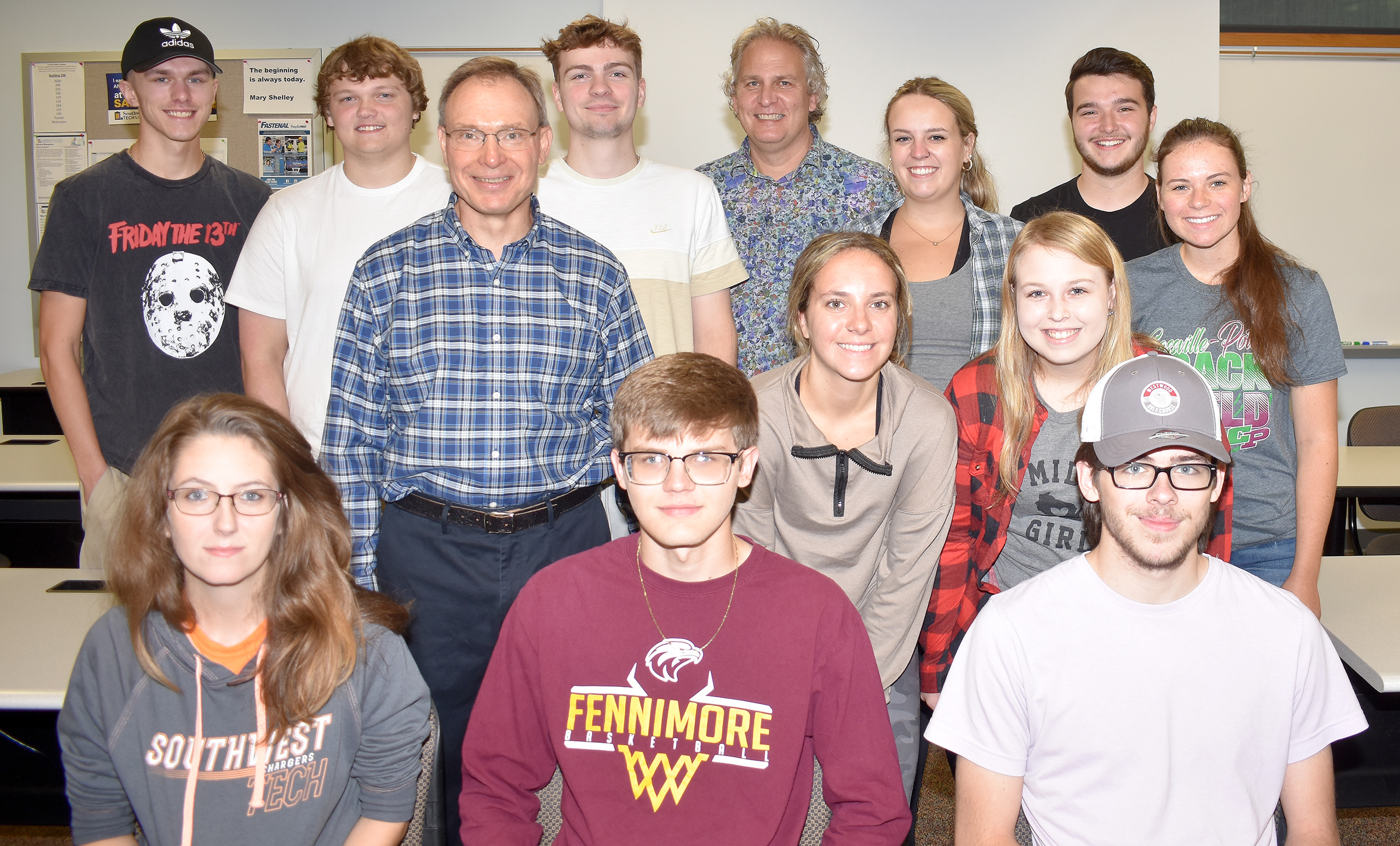 Paul Bell with a group of students in a classroom.