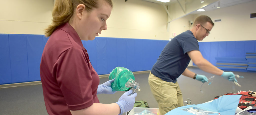 FEMALE ON LEFT AND MALE ON RIGHT TRAINING AS EMTS