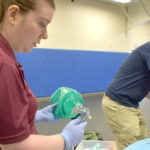 FEMALE ON LEFT AND MALE ON RIGHT TRAINING AS EMTS