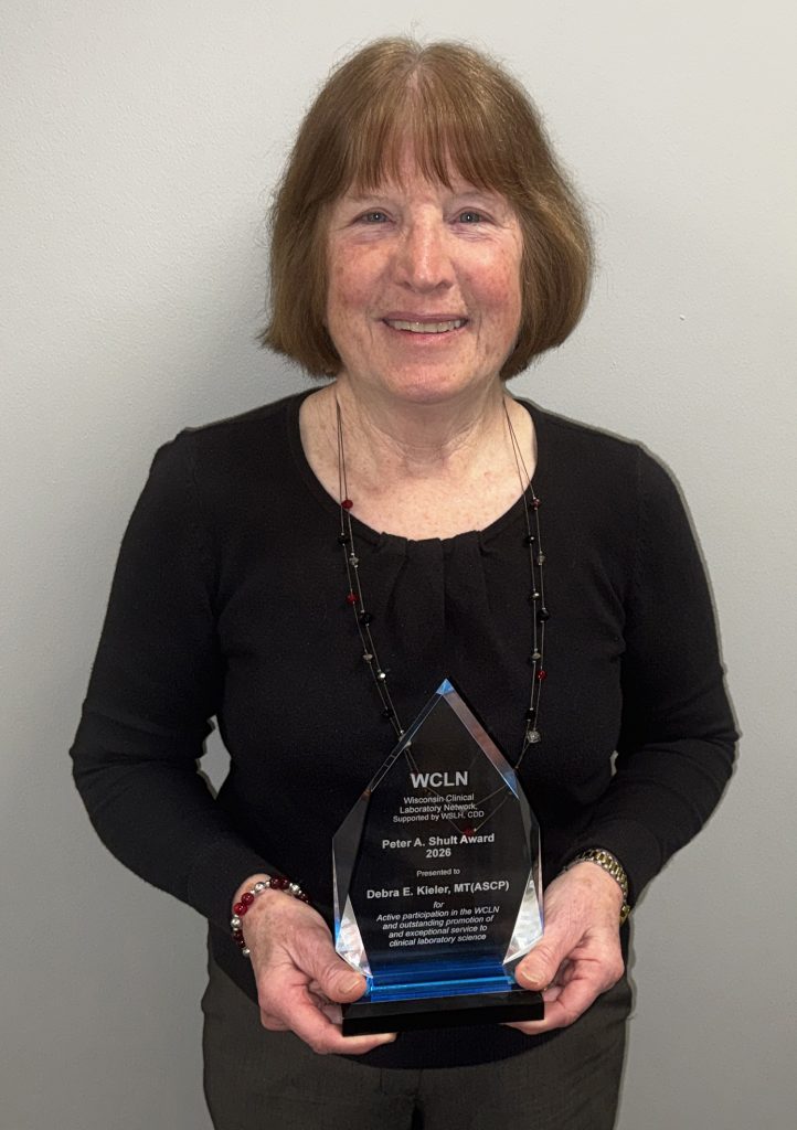 Debra Kieler holding the award.