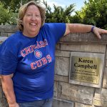 Karen standing in front of a plaque outside.