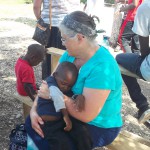 Southwest Tech Nursing instructor with Haitian child