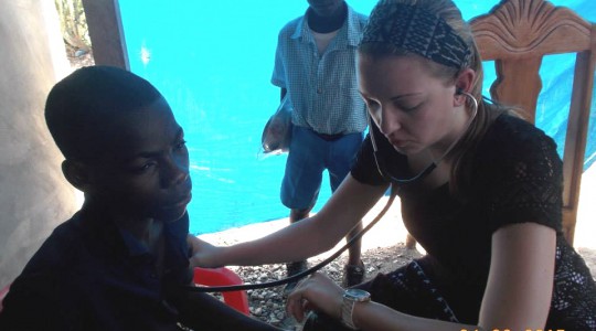 Southwest Tech student checking haitian boy