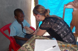 Southwest Tech student checking haitian boy